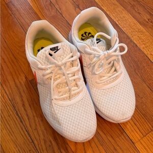 Women’s Nike running sneakers with neon orange/pink check